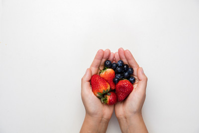 hands holding fresh fruit in palm