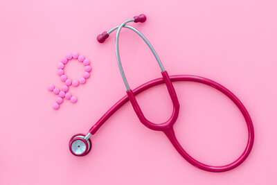 Women's Health issues. Medical concept with Venus sign and stethoscope on pink background top-down