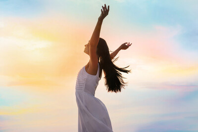 Young woman enjoying summer day against sky.