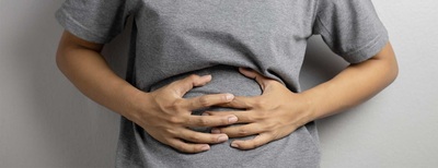 IBD hero person holding stomach